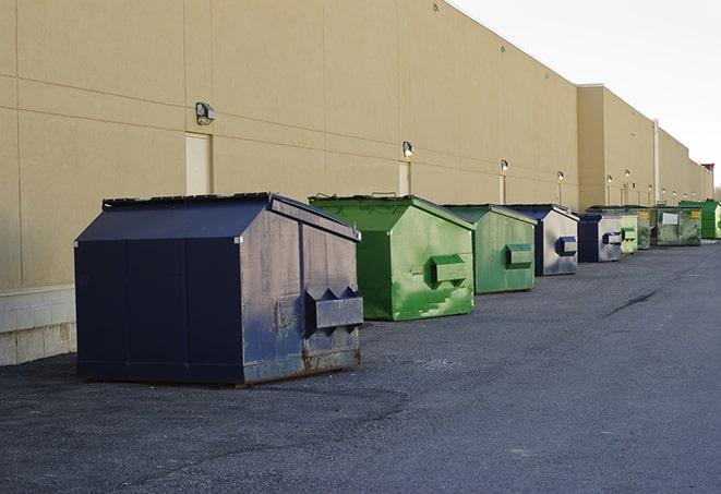 a group of construction workers taking a break near a dumpster in Edison NJ